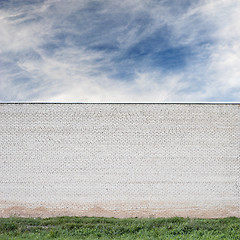 Image showing Blue sky with clouds behind the huge wall