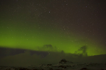 Image showing Northern lights with snowy mountains in the foreground