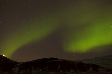 Image showing Northern lights with snowy mountains in the foreground