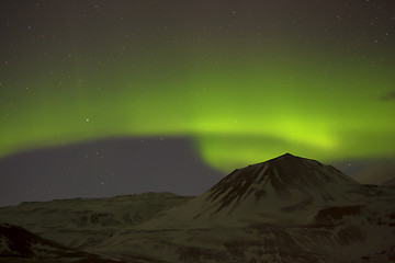 Image showing Northern lights with snowy mountains in the foreground