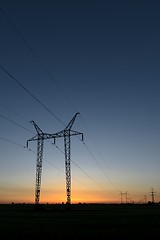 Image showing Large transmission towers at sunset