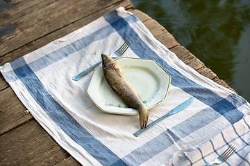 Image showing Wooden deck with fish on it