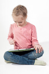 Image showing Little girl uses a tablet PC