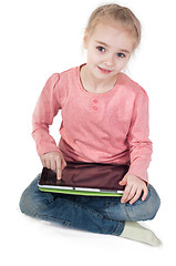 Image showing Little girl uses a tablet PC