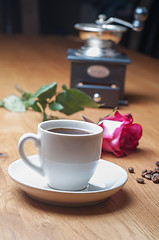 Image showing Vintage coffee mill, cup and rose