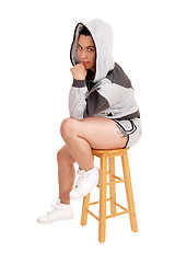 Image showing Girl sitting in hoodie on a chair.