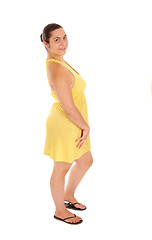 Image showing Standing woman in yellow dress.