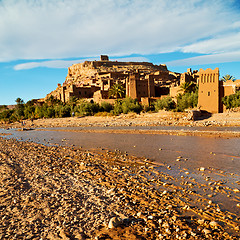 Image showing sunset in africa old construction near the river blue