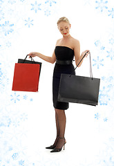 Image showing shopping blond in black dress with snowflakes