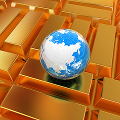 Image showing Earth and gold bars