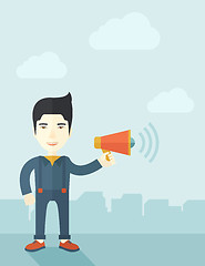 Image showing Businessman in the field holding a megaphone.