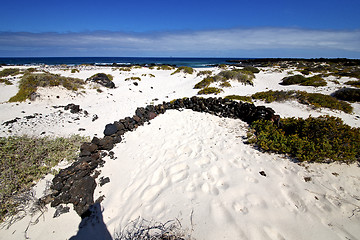 Image showing spain white  beach  spiral of black rocks