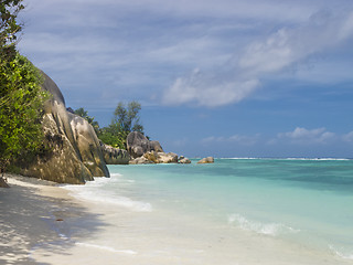 Image showing Pristine tropical beach surrounded by granite boulders