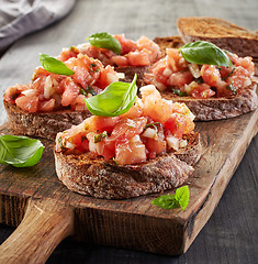 Image showing toasted bread with chopped tomatoes