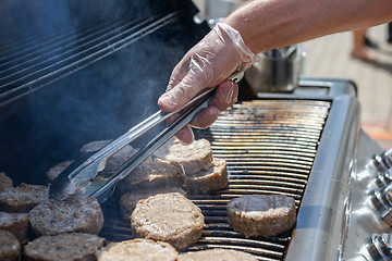 Image showing cooking steaks on a hot grill