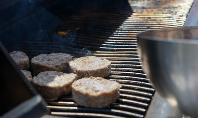 Image showing cooking steaks on a hot grill