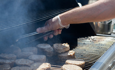 Image showing cooking steaks on a hot grill