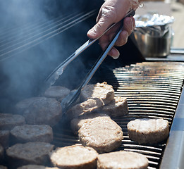 Image showing cooking steaks on a hot grill