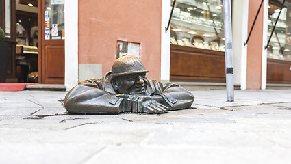 Image showing BRATISLAVA, SLOVAKIA - MAY 07, 2013: Cumil (The Watcher) - famous statue of man peeking out from under a manhole cover.