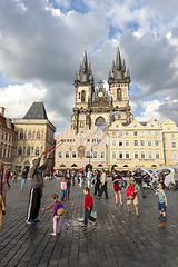 Image showing PRAGUE, CZECH REPUBLIC - May 08, 2013: A man doing huge bubbles and amazed kids. Street Art.