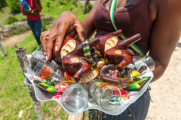 Image showing OCHO RIOS, JAMAICA - MAY 07, 2012:  Souvenirs on the glass tray in the hands of the local women