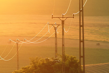 Image showing electric pillars at sunset