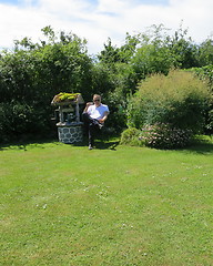 Image showing Man in cottage garden