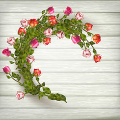 Image showing Roses wreath on wooden background. EPS 10