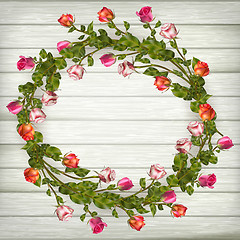 Image showing Roses wreath on wooden background. EPS 10