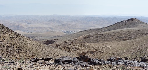 Image showing Desert landscape with far Bedouin camp on hazy day