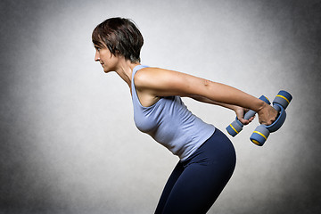 Image showing Middle aged woman with dumbbells