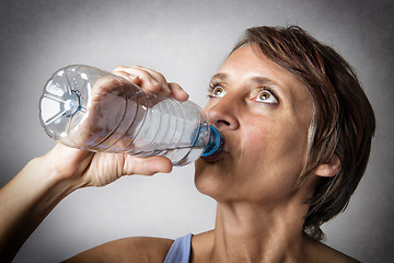 Image showing Middle aged woman drinking