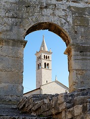 Image showing Bell tower of Saint Anthony Church in Pula, Croatia seen through the arc of Pula Amphitheater