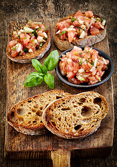 Image showing bruschettas ingredients on wooden cutting board