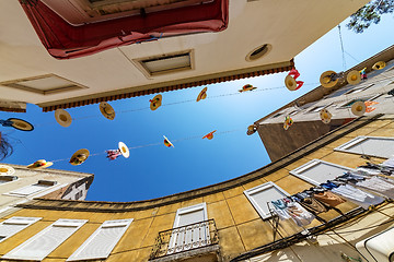 Image showing City Streets Decorated with Straw Hats