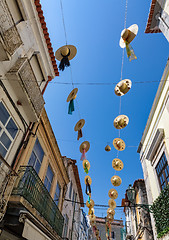 Image showing City Streets Decorated with Straw Hats
