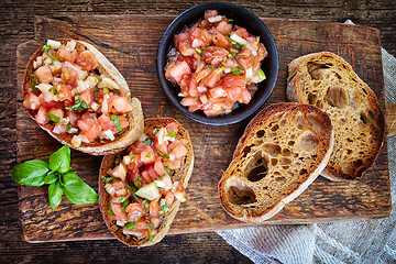 Image showing bruschettas ingredients on wooden cutting board