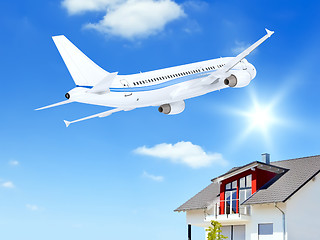 Image showing airplane over house