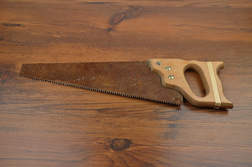 Image showing Hand saw on wood