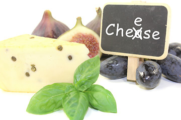 Image showing Piece of cheese with pepper and blackboard