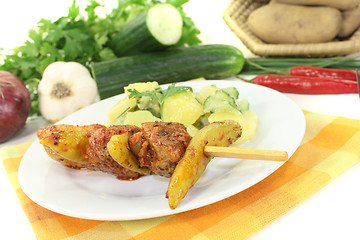 Image showing Potato-cucumber salad with fire skewers of pork