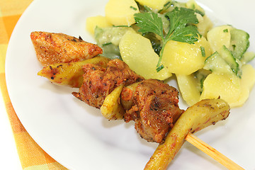 Image showing Potato-cucumber salad with fire skewers