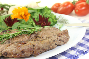 Image showing fried Sirloin steak with wild herb salad