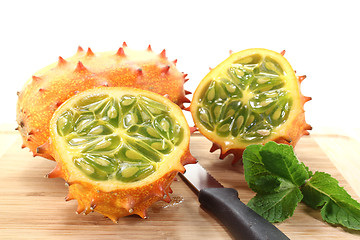 Image showing sliced horned melon on a wooden board