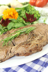 Image showing Sirloin steak with wild herb salad and rosemary