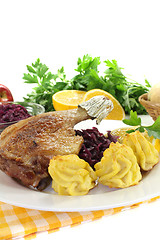 Image showing hot Duck leg with red cabbage