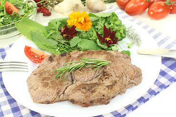 Image showing Sirloin steak with wild herb salad