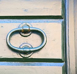 Image showing abstract cross   brass brown knocker    closed wood door  tradat