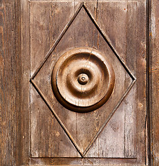 Image showing abstract  rusty brass brown knocker in a   closed wood door solb
