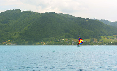 Image showing Sailboat with a colourful sail on an alpine lake
